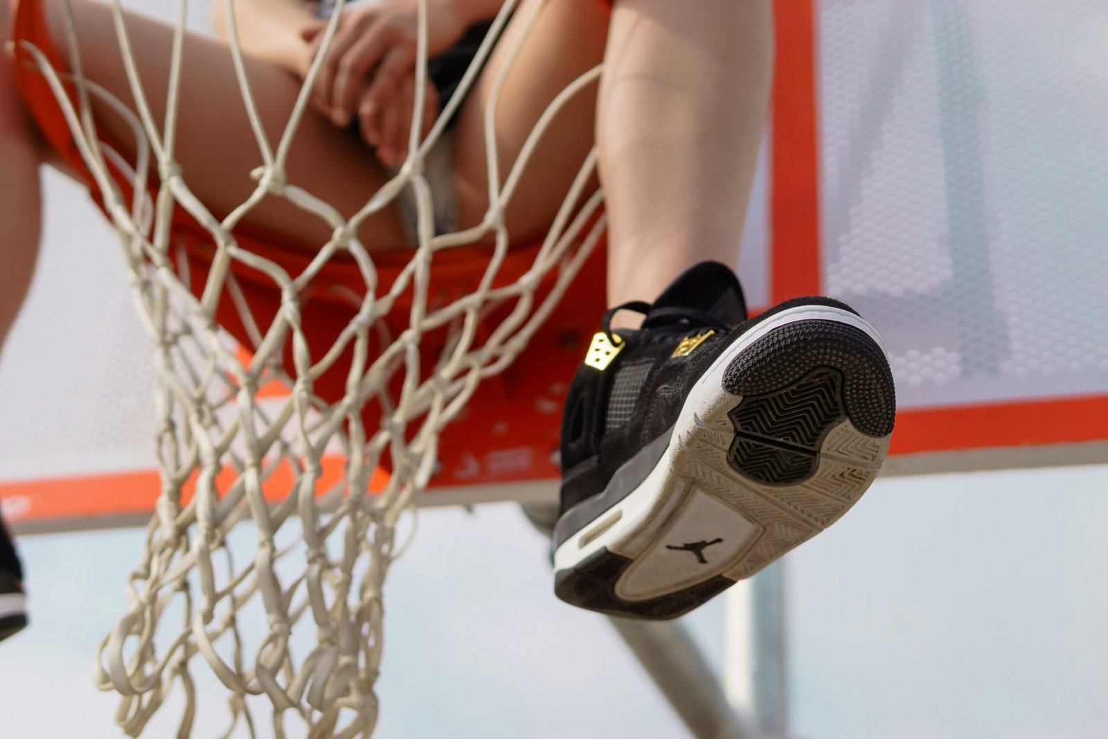 person wearing black and white nike sneakers